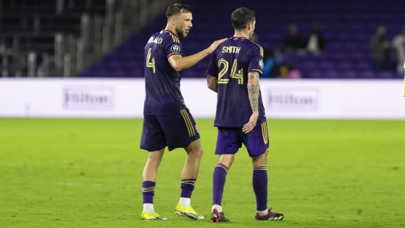 Mar 5, 2024; Orlando, FL, USA; Orlando City defender David Brekalo (4) and defender Kyle Smith (24) after the game against Tigres UNAL at INTER& CO Stadium. Mandatory Credit: Morgan Tencza-USA TODAY Sports