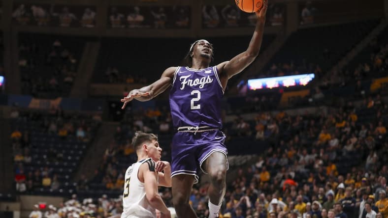 Mar 6, 2024; Morgantown, West Virginia, USA; TCU Horned Frogs forward Emanuel Miller (2) shoots in the lane during the first half against the West Virginia Mountaineers at WVU Coliseum. Mandatory Credit: Ben Queen-USA TODAY Sports