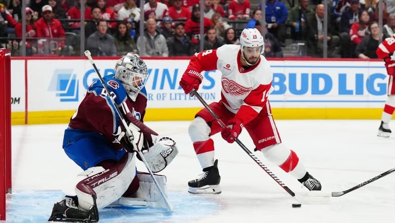 Mar 6, 2024; Denver, Colorado, USA; Detroit Red Wings center Robby Fabbri (14) shoots and scores on Colorado Avalanche goaltender Alexandar Georgiev (40) in the first period at Ball Arena. Mandatory Credit: Ron Chenoy-USA TODAY Sports