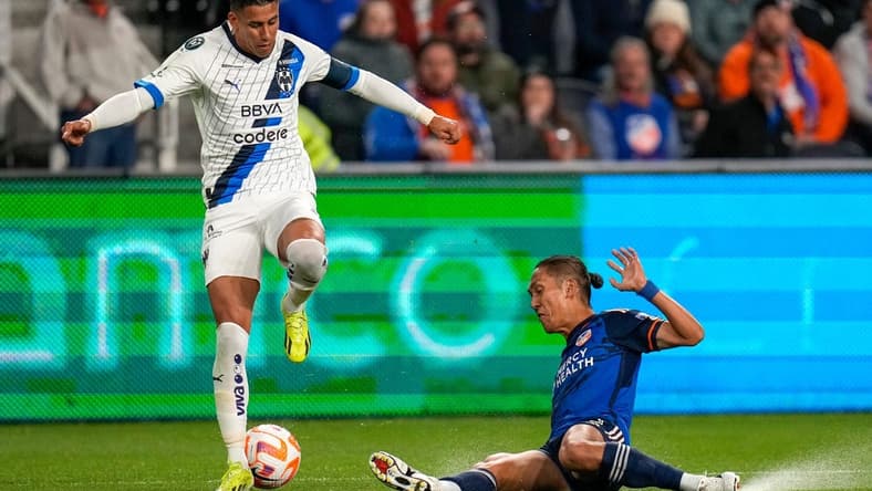 FC Cincinnati forward Yuya Kubo (7) slides under Monterrey midfielder Maximiliano Meza (11) in the first half of the CONCACAF Champions Cup Round of 16 game between the FC Cincinnati and the Monterrey at TQL Stadium in Cincinnati on Thursday, March 7, 2024. Monterrey led 1-0 at halftime.
