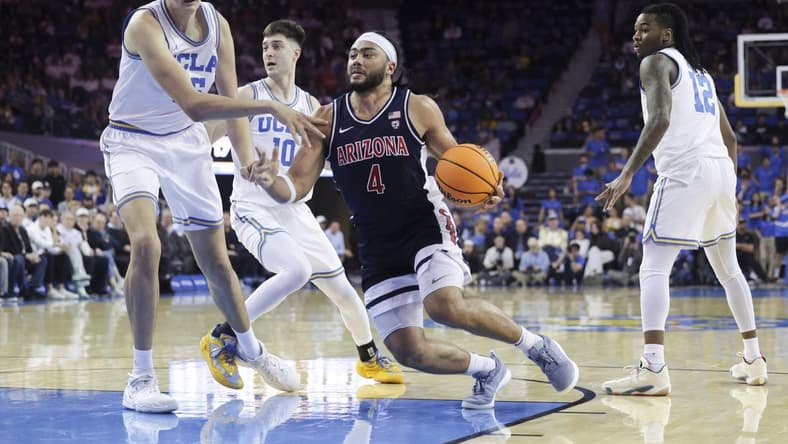 Mar 7, 2024; Los Angeles, California, USA; Arizona Wildcats guard Kylan Boswell (4) drives the ball against UCLA defenders during the first half at Pauley Pavilion presented by Wescom. Mandatory Credit: Yannick Peterhans-USA TODAY Sports