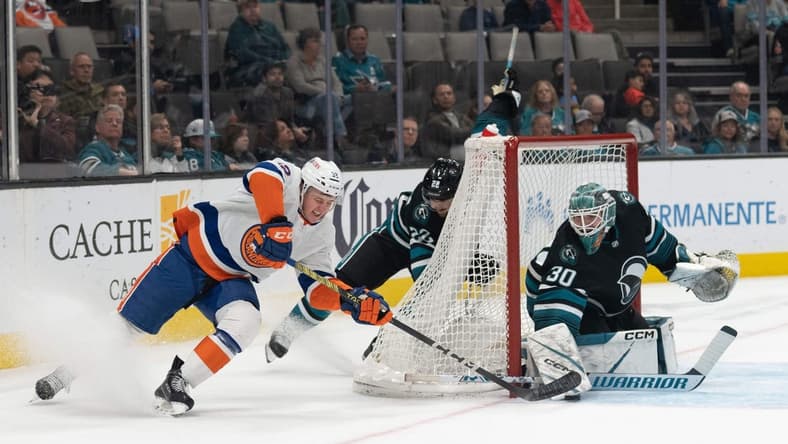 Mar 7, 2024; San Jose, California, USA; New York Islanders center Kyle MacLean (32) attempts to shoot the puck during the first period against San Jose Sharks goaltender Magnus Chrona (30) at SAP Center at San Jose. Mandatory Credit: Stan Szeto-USA TODAY Sports