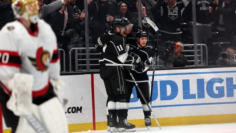 Mar 7, 2024; Los Angeles, California, USA; Los Angeles Kings right wing Quinton Byfield (55, center) celebrates a goal with center Anze Kopitar (11) and center Blake Lizotte (46) during the second period against the Ottawa Senators at Crypto.com Arena. Mandatory Credit: Kiyoshi Mio-USA TODAY Sports