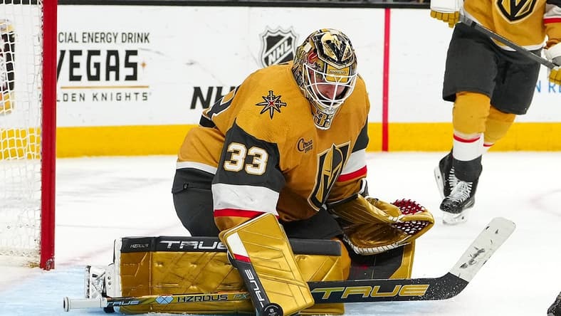 Mar 7, 2024; Las Vegas, Nevada, USA; Vegas Golden Knights goaltender Adin Hill (33) makes as save against the Vancouver Canucks during the third period at T-Mobile Arena. Mandatory Credit: Stephen R. Sylvanie-USA TODAY Sports