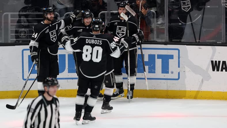 Mar 7, 2024; Los Angeles, California, USA; Los Angeles Kings left wing Kevin Fiala (22, center) celebrates a goal with center Phillip Danault (24) and defenseman Matt Roy (3) and center Pierre-Luc Dubois (80) during the overtime against the Ottawa Senators at Crypto.com Arena. Mandatory Credit: Kiyoshi Mio-USA TODAY Sports