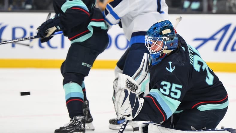 Mar 8, 2024; Seattle, Washington, USA; Seattle Kraken goaltender Joey Daccord (35) blocks a goal shot against the Winnipeg Jets during the first period at Climate Pledge Arena. Mandatory Credit: Steven Bisig-USA TODAY Sports