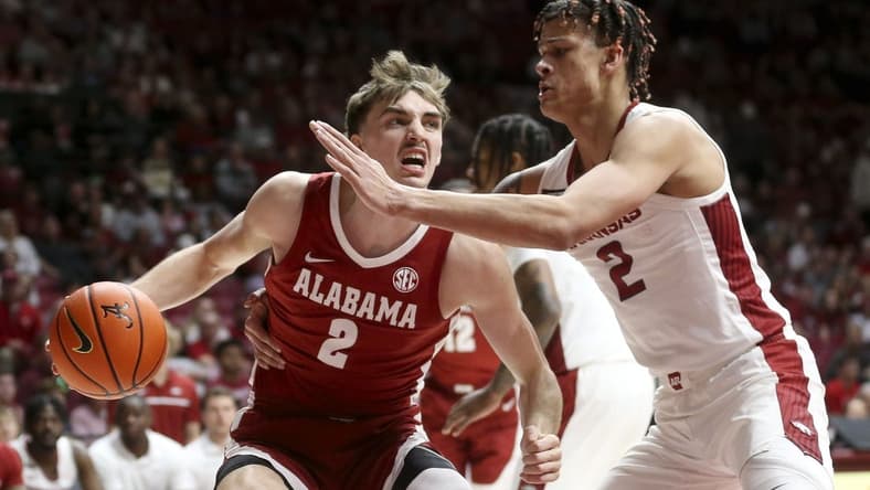 Mar 9, 2024; Tuscaloosa, Alabama, USA; Alabama Crimson Tide forward Grant Nelson (2) drives against Arkansas Razorbacks forward Trevon Brazile (2) at Coleman Coliseum. Mandatory Credit: Gary Cosby Jr.-USA TODAY Sports