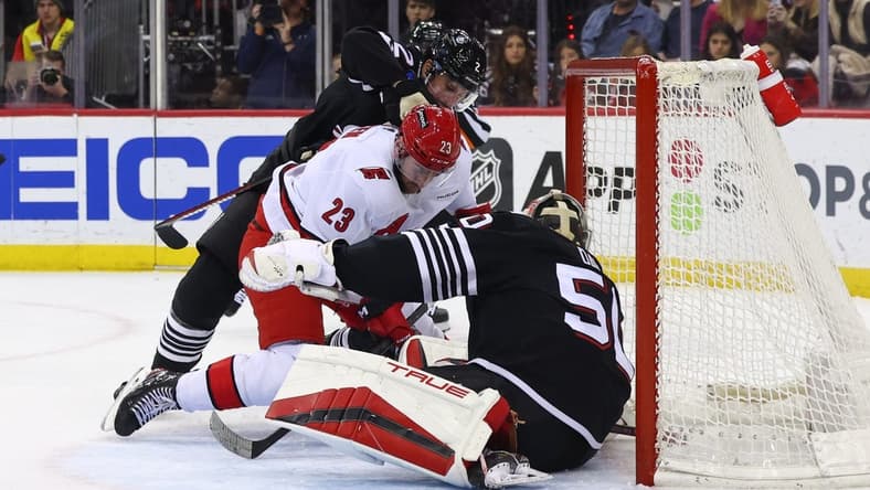 Mar 9, 2024; Newark, New Jersey, USA; New Jersey Devils goaltender Nico Daws (50) makes a save against the Carolina Hurricanes during the first period at Prudential Center. Mandatory Credit: Ed Mulholland-USA TODAY Sports