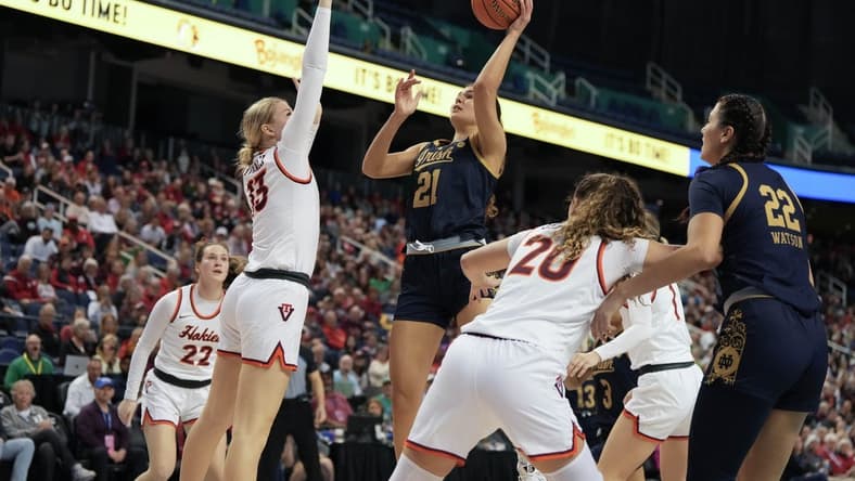 Mar 9, 2024; Greensboro, NC, USA; Notre Dame Fighting Irish forward Maddy Westbeld (21) shoots the ball over Notre Dame Fighting Irish guard Anna DeWolfe (13) during the second half at Greensboro Coliseum. Mandatory Credit: David Yeazell-USA TODAY Sports