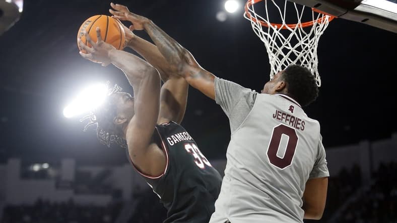 Mar 9, 2024; Starkville, Mississippi, USA; South Carolina Gamecocks forward Josh Gray (33) shoots as Mississippi State Bulldogs forward D.J. Jeffries (0) defends during the first half at Humphrey Coliseum. Mandatory Credit: Petre Thomas-USA TODAY Sports