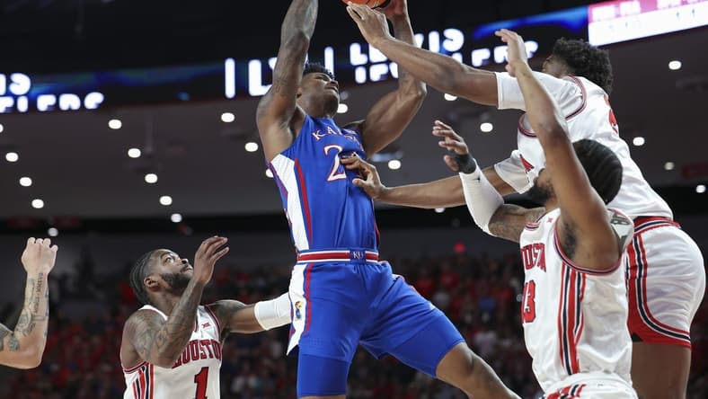 Mar 9, 2024; Houston, Texas, USA; Kansas Jayhawks forward K.J. Adams Jr. (24) attempts to control the ball as Houston Cougars center Cedric Lath (2) defends during the first half at Fertitta Center. Mandatory Credit: Troy Taormina-USA TODAY Sports