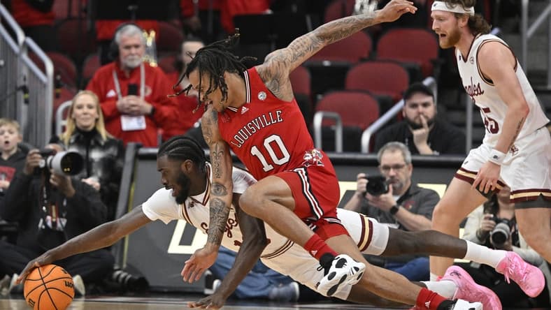 Mar 9, 2024; Louisville, Kentucky, USA; Boston College Eagles guard Prince Aligbe (10) dives for the ball with Louisville Cardinals forward Kaleb Glenn (10) during the first half at KFC Yum! Center. Mandatory Credit: Jamie Rhodes-USA TODAY Sports