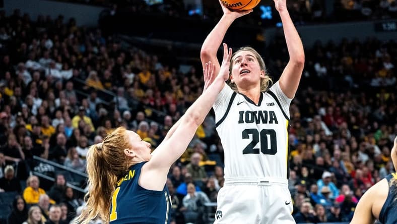 Iowa guard Kate Martin (20) attempts a shot against Michigan guard Lauren Hansen (1) during the Big Ten Tournament semifinals at the Target Center on Saturday, March 9, 2024, in Minneapolis, Minn.