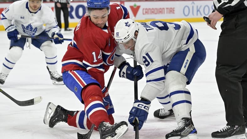 Mar 9, 2024; Montreal, Quebec, CAN: Montreal Canadiens forward Nick Suzuki (14) wins a faceoff against Toronto Maple Leafs forward John Tavares (91) during the first period at the Bell Centre. Mandatory Credit: Eric Bolte-USA TODAY Sports