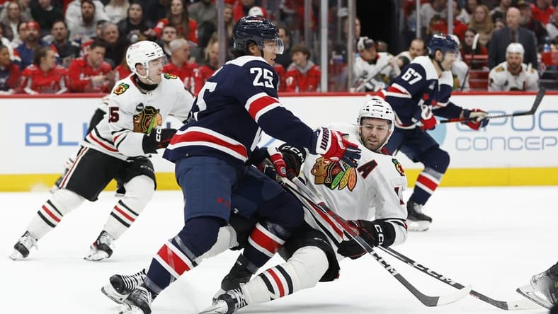 Mar 9, 2024; Washington, District of Columbia, USA; Washington Capitals defenseman Ethan Bear (25) checks Chicago Blackhawks center Jason Dickinson (16) in the second period at Capital One Arena. Mandatory Credit: Geoff Burke-USA TODAY Sports