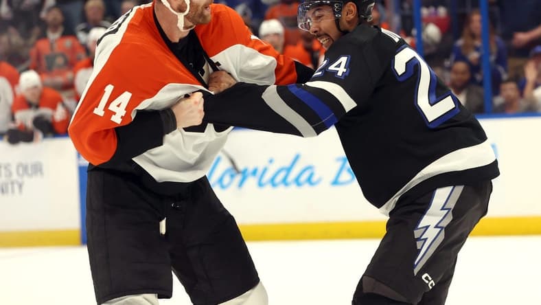 Mar 9, 2024; Tampa, Florida, USA;Philadelphia Flyers center Sean Couturier (14) and Tampa Bay Lightning defenseman Matt Dumba (24) fight during the second period at Amalie Arena. Mandatory Credit: Kim Klement Neitzel-USA TODAY Sports