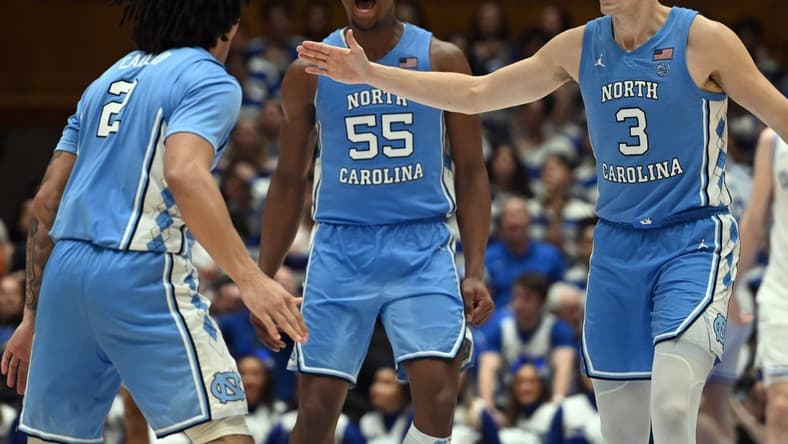 Mar 9, 2024; Durham, North Carolina, USA; North Carolina Tar Heels guard Cormac Ryan (3) and forward Harrison Ingram (55) react to a basket by guard Elliot Cadeau (2) during the second half against the Duke Blue Devils at Cameron Indoor Stadium. The Tar Heels won 84-79. Mandatory Credit: Rob Kinnan-USA TODAY Sports