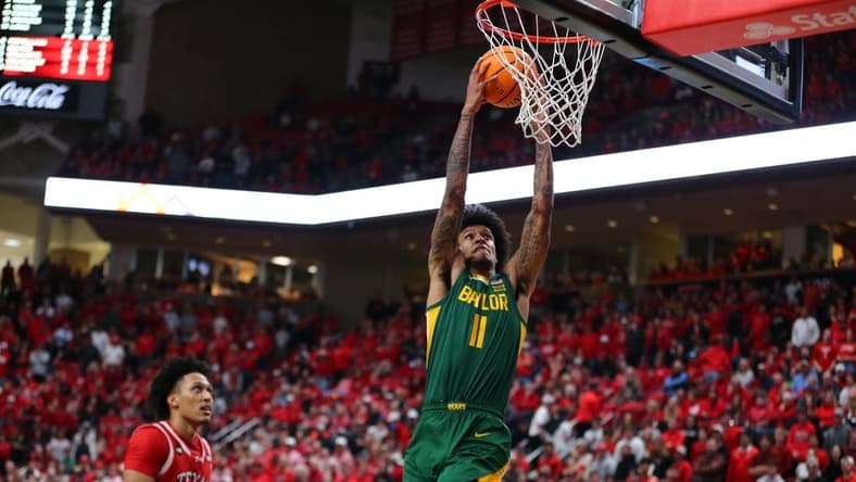 Mar 9, 2024; Lubbock, Texas, USA;  Baylor Bears forward Jalen Bridges (11) dunks the ball against Texas Tech Red Raiders guard Darrion Williams (5) in the second half at United Supermarkets Arena. Mandatory Credit: Michael C. Johnson-USA TODAY Sports