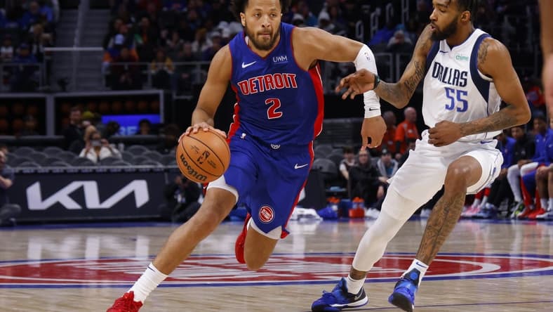 Mar 9, 2024; Detroit, Michigan, USA; Detroit Pistons guard Cade Cunningham (2) dribbles defended by Dallas Mavericks forward Derrick Jones Jr. (55) in the second half at Little Caesars Arena. Mandatory Credit: Rick Osentoski-USA TODAY Sports