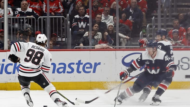 Mar 9, 2024; Washington, District of Columbia, USA; Chicago Blackhawks center Connor Bedard (98) skates with the puck as Washington Capitals left wing Beck Malenstyn (47) and Capitals defenseman Nick Jensen (3) defend in the third period at Capital One Arena. Mandatory Credit: Geoff Burke-USA TODAY Sports