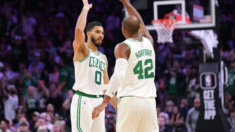 Mar 9, 2024; Phoenix, Arizona, USA; Boston Celtics forward Jayson Tatum (0) and Boston Celtics center Al Horford (42) slap hands during the second half of the game against the Phoenix Suns at Footprint Center. Mandatory Credit: Joe Camporeale-USA TODAY Sports