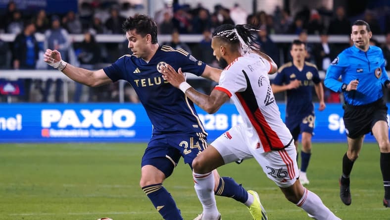 Mar 9, 2024; San Jose, California, USA; Vancouver Whitecaps FC forward Brian White (24) and San Jose Earthquakes defender Rodrigues (26) battle for the ball during the first half at PayPal Park. Mandatory Credit: Kelley L Cox-USA TODAY Sports