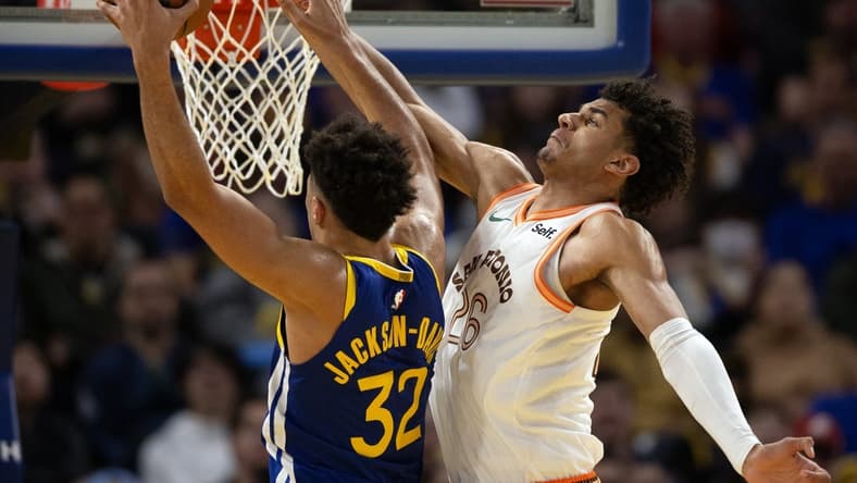 Mar 9, 2024; San Francisco, California, USA; Golden State Warriors forward Trayce Jackson-Davis (32) manages to get a shot around the defense of San Antonio Spurs forward Dominick Barlow (26) during the third quarter at Chase Center. Mandatory Credit: D. Ross Cameron-USA TODAY Sports
