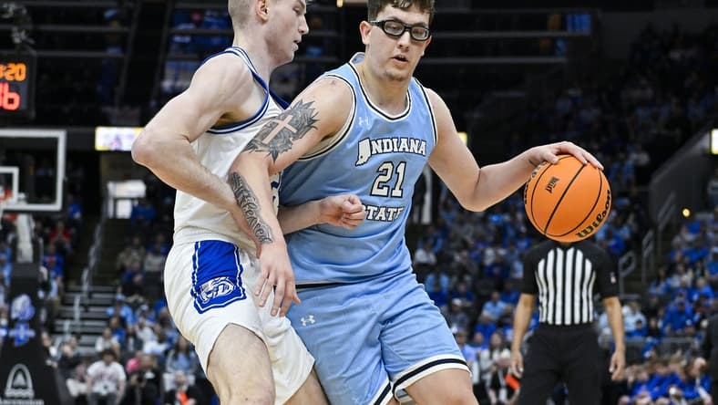 Mar 10, 2024; St. Louis, MO, USA; Indiana State Sycamores center Robbie Avila (21) drives to the basket as Drake Bulldogs forward Nate Ferguson (24) defends during the first half of the Missouri Valley Conference Tournament Championship game at Enterprise Center. Mandatory Credit: Jeff Curry-USA TODAY Sports