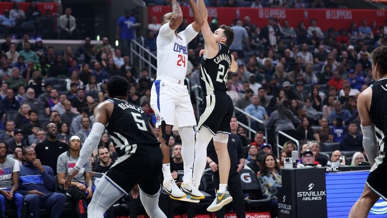 Mar 10, 2024; Los Angeles, California, USA; Los Angeles Clippers guard Norman Powell (24) shoots the ball over Milwaukee Bucks guard Pat Connaughton (24) during the first quarter at Crypto.com Arena. Mandatory Credit: Kiyoshi Mio-USA TODAY Sports