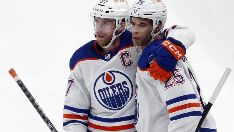 Mar 10, 2024; Pittsburgh, Pennsylvania, USA;  Edmonton Oilers center Connor McDavid (left) congratulates  defenseman Darnell Nurse (25) after Nurse scored a goal against the Pittsburgh Penguins during the third period at PPG Paints Arena. The Oilers won 4-0. Mandatory Credit: Charles LeClaire-USA TODAY Sports