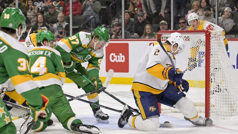 Mar 10, 2024; Saint Paul, Minnesota, USA;  Minnesota Wild forward Kirill Kaprizov (97) scores a power play goal as Nashville Predators defenseman Luke Schenn (2) looks for the puck during the second period at Xcel Energy Center. Mandatory Credit: Nick Wosika-USA TODAY Sports