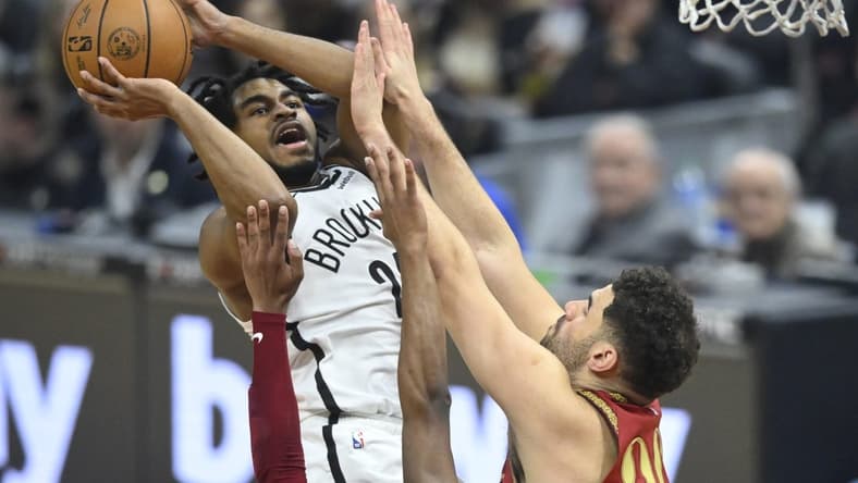 Mar 10, 2024; Cleveland, Ohio, USA; Brooklyn Nets guard Cam Thomas (24) shoots beside Cleveland Cavaliers forward Georges Niang (20) in the first quarter at Rocket Mortgage FieldHouse. Mandatory Credit: David Richard-USA TODAY Sports