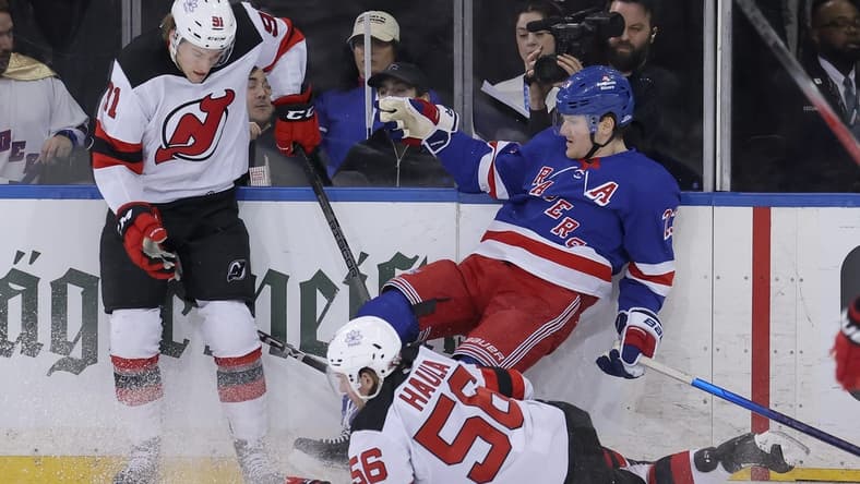 Mar 11, 2024; New York, New York, USA; New Jersey Devils center Dawson Mercer (91) and left wing Erik Haula (56) hit New York Rangers defenseman Adam Fox (23) during the second period at Madison Square Garden. Mandatory Credit: Brad Penner-USA TODAY Sports