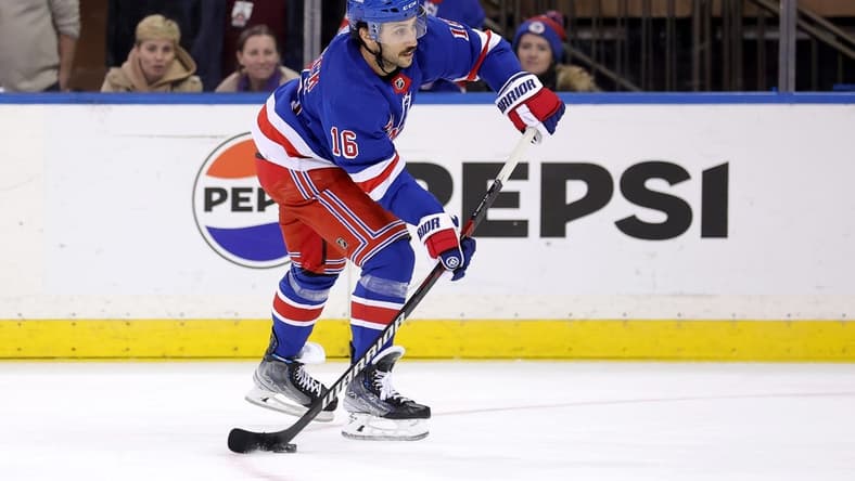 Mar 11, 2024; New York, New York, USA; New York Rangers center Vincent Trocheck (16) shoots and scores an empty net goal against the New Jersey Devils during the third period at Madison Square Garden. Mandatory Credit: Brad Penner-USA TODAY Sports