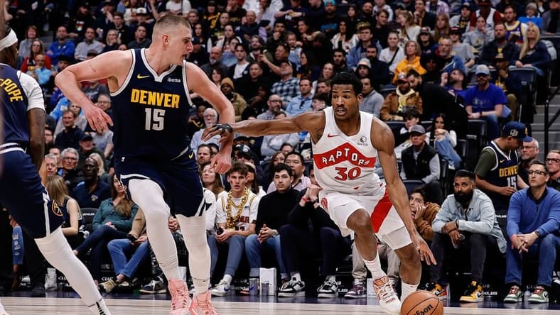Mar 11, 2024; Denver, Colorado, USA; Toronto Raptors guard Ochai Agbaji (30) drives to the basket against Denver Nuggets center Nikola Jokic (15) in the second quarter at Ball Arena. Mandatory Credit: Isaiah J. Downing-USA TODAY Sports