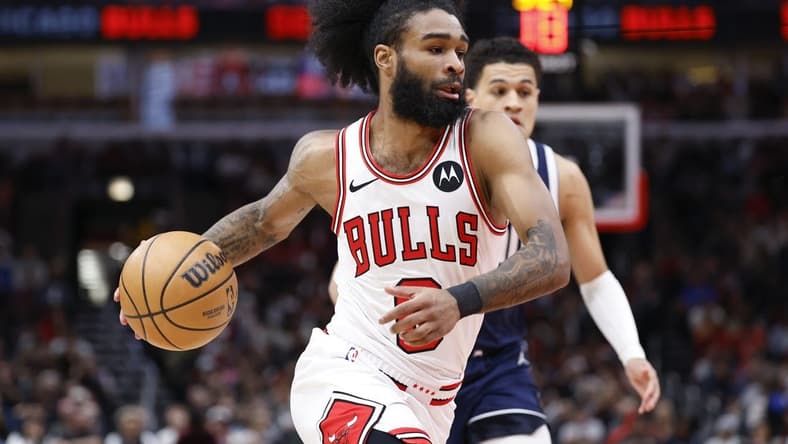 Mar 11, 2024; Chicago, Illinois, USA; Chicago Bulls guard Coby White (0) drives to the basket against the Dallas Mavericks during the first half at United Center. Mandatory Credit: Kamil Krzaczynski-USA TODAY Sports