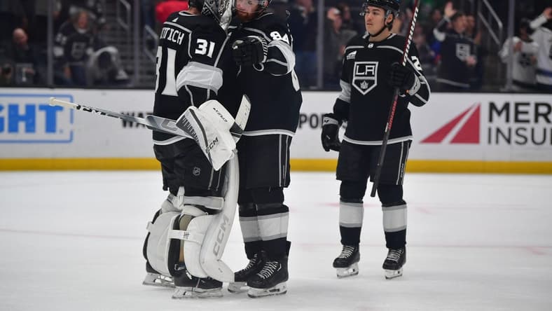 Mar 11, 2024; Los Angeles, California, USA; Los Angeles Kings goaltender David Rittich (31) defenseman Vladislav Gavrikov (84) and defenseman Jordan Spence (21) celebrate the victory against the New York Islanders at Crypto.com Arena. Mandatory Credit: Gary A. Vasquez-USA TODAY Sports