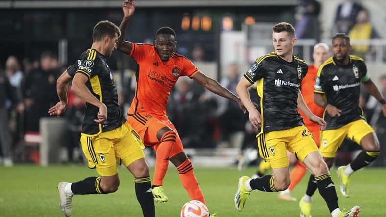 Mar 12, 2024; Columbus, OH, USA;  Columbus Crew defender Yevhen Cheberko (21) kicks the ball from Houston Dynamo forward Ibrahim Aliyu (18) during the second half of the Concacaf Champions Cup soccer game at Lower.com Field. Mandatory Credit: Adam Cairns-USA TODAY Sports