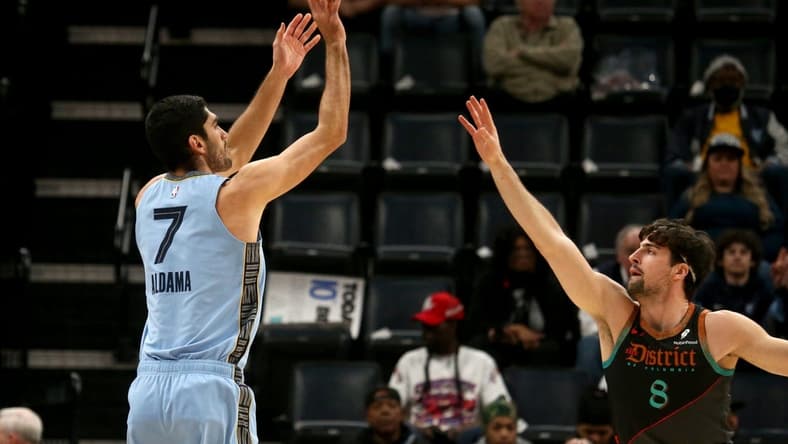 Mar 12, 2024; Memphis, Tennessee, USA; Memphis Grizzlies forward-center Santi Aldama (7) shoots for three as Washington Wizards forward Deni Avdija (8) defends during the first half at FedExForum. Mandatory Credit: Petre Thomas-USA TODAY Sports