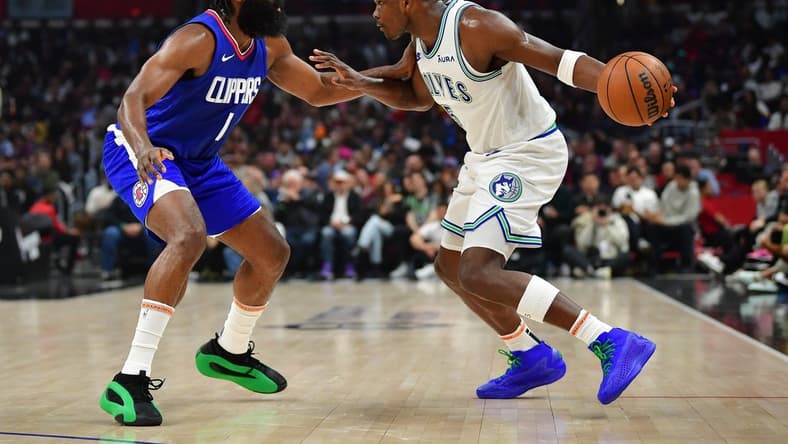 Mar 12, 2024; Los Angeles, California, USA; Minnesota Timberwolves guard Anthony Edwards (5) controls the ball against Los Angeles Clippers guard James Harden (1) during the first half at Crypto.com Arena. Mandatory Credit: Gary A. Vasquez-USA TODAY Sports