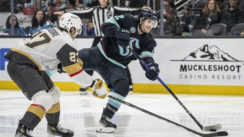 Mar 12, 2024; Seattle, Washington, USA; Seattle Kraken forward Tye Kartye (52) takes a shot Vegas Golden Knights defenseman Shea Theodore (27) during the second period at Climate Pledge Arena. Mandatory Credit: Stephen Brashear-USA TODAY Sports