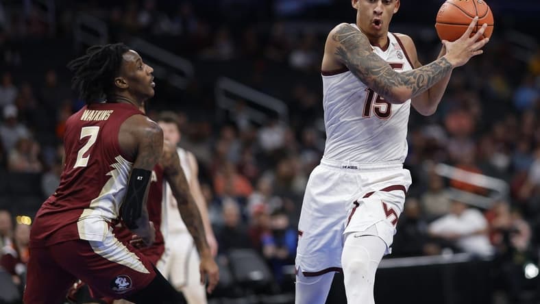 Mar 13, 2024; Washington, D.C., USA; Virginia Tech Hokies center Lynn Kidd (15) drives to the basket as Florida State Seminoles forward Jamir Watkins (2) defends in the first half at Capital One Arena. Mandatory Credit: Geoff Burke-USA TODAY Sports