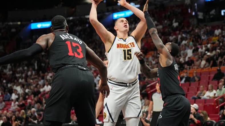 Mar 13, 2024; Miami, Florida, USA; Denver Nuggets center Nikola Jokic (15) takes a shot over Miami Heat guard Terry Rozier (2) during the first half at Kaseya Center. Mandatory Credit: Jim Rassol-USA TODAY Sports