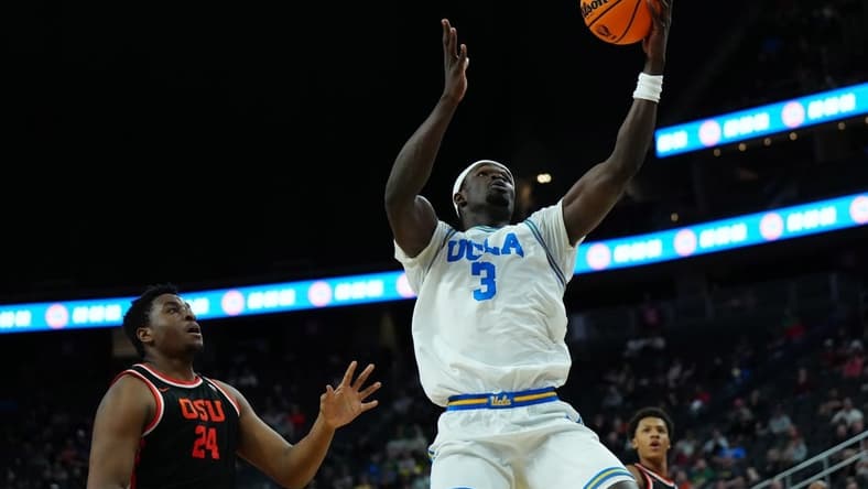 Mar 13, 2024; Las Vegas, NV, USA; UCLA Bruins forward Adem Bona (3) catches the ball against Oregon State Beavers center KC Ibekwe (24) in the first half at T-Mobile Arena. Mandatory Credit: Kirby Lee-USA TODAY Sports