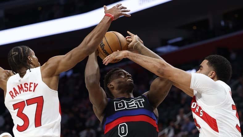 Mar 13, 2024; Detroit, Michigan, USA;  Detroit Pistons center Jalen Duren (0) grabs the rebound over Toronto Raptors guard Jahmi'us Ramsey (37) in the first half at Little Caesars Arena. Mandatory Credit: Rick Osentoski-USA TODAY Sports