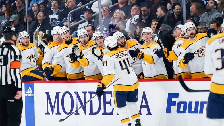Mar 13, 2024; Winnipeg, Manitoba, CAN; Nashville Predators forward Keifer Sherwood (44) is congratulated by his team mates on his goal against the Winnipeg Jets during the first period at Canada Life Centre. Mandatory Credit: Terrence Lee-USA TODAY Sports