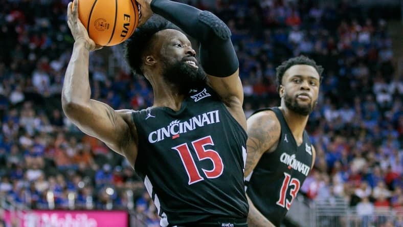 Mar 13, 2024; Kansas City, MO, USA; Cincinnati Bearcats forward John Newman III (15) grabs the rebound during the first half against the Kansas Jayhawks at T-Mobile Center. Mandatory Credit: William Purnell-USA TODAY Sports