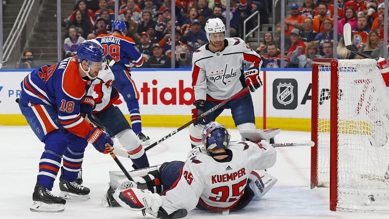 Mar 13, 2024; Edmonton, Alberta, CAN; Edmonton Oilers forward Zach Hyman (18) scores a goal during the first period against Washington Capitals goaltender Darcy Kuemper (35) at Rogers Place. Mandatory Credit: Perry Nelson-USA TODAY Sports