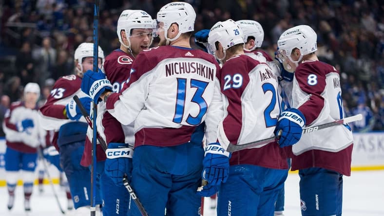 Mar 13, 2024; Vancouver, British Columbia, CAN; Colorado Avalanche forward Mikko Rantanen (96) and forward Valeri Nichushkin (13) and forward Nathan MacKinnon (29) and defenseman Cale Makar (8) celebrate MacKinnon   s game winning overtime goal against the Vancouver Canucks Rogers Arena. Colorado won 4 -3 in overtime. Mandatory Credit: Bob Frid-USA TODAY Sports