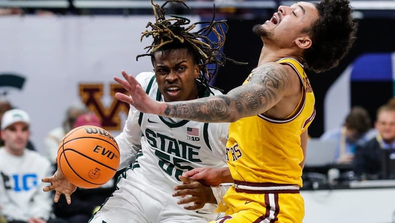 Michigan State forward Coen Carr (55) dribbles against Minnesota guard Braeden Carrington (4) during the first half of Second Round of Big Ten tournament at Target Center in Minneapolis, Minn. on Thursday, March 14, 2024.